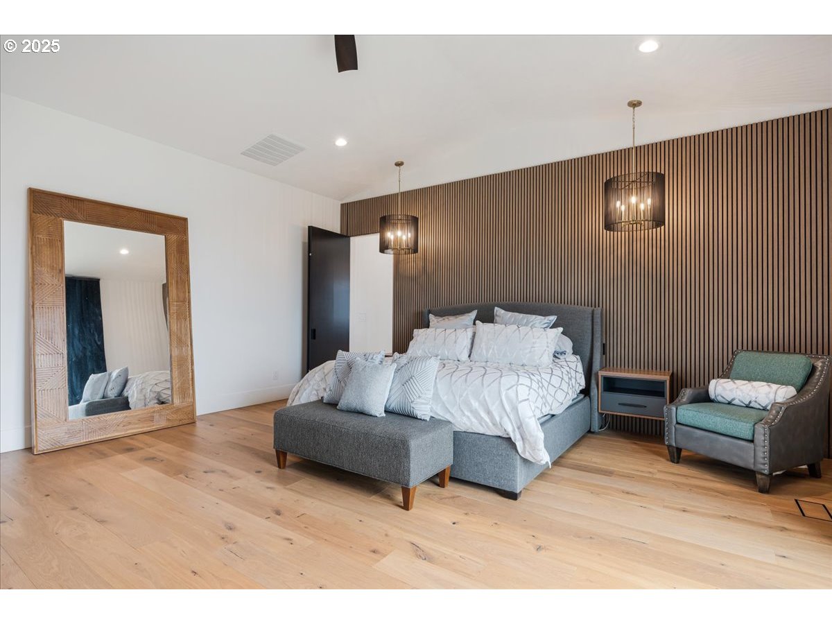 23067 Southwest Curry Ridge Drive Sherwood, OR 97140 - Photo 17 of 48 a spacious bedroom with a bed and a couch