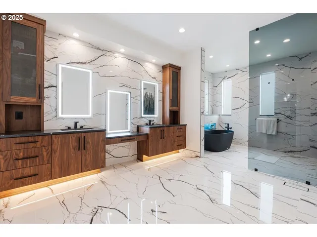 a large bathroom with a tub sink and mirror