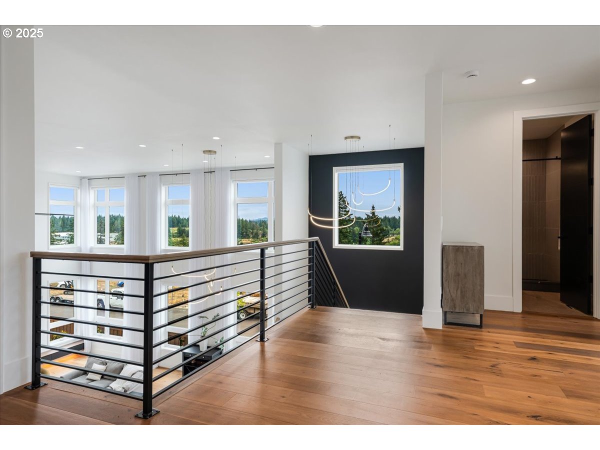 23067 Southwest Curry Ridge Drive Sherwood, OR 97140 - Photo 23 of 48 a view of a bedroom with wooden floor and windows