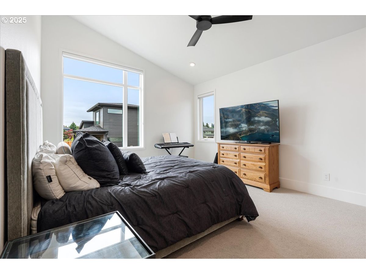 23067 Southwest Curry Ridge Drive Sherwood, OR 97140 - Photo 24 of 48 a bedroom with a bed window and mirror