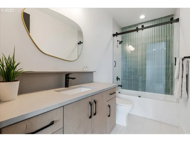 a bathroom with a sink a glass door shower and a mirror