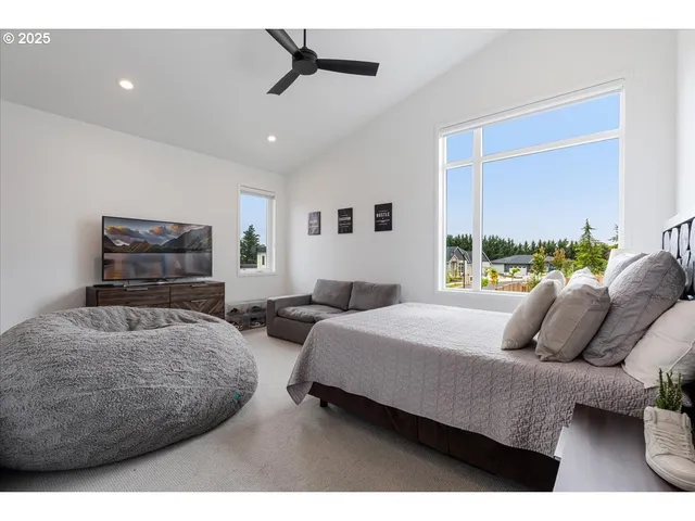 a bedroom with two beds and a large window