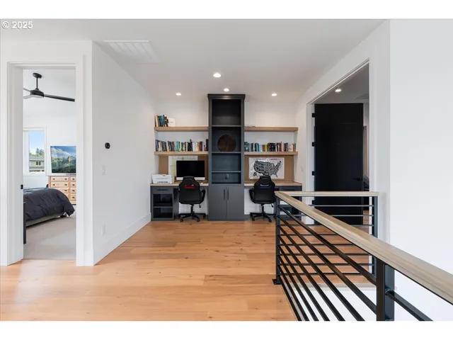 a living room with stainless steel appliances furniture a kitchen view and a fireplace