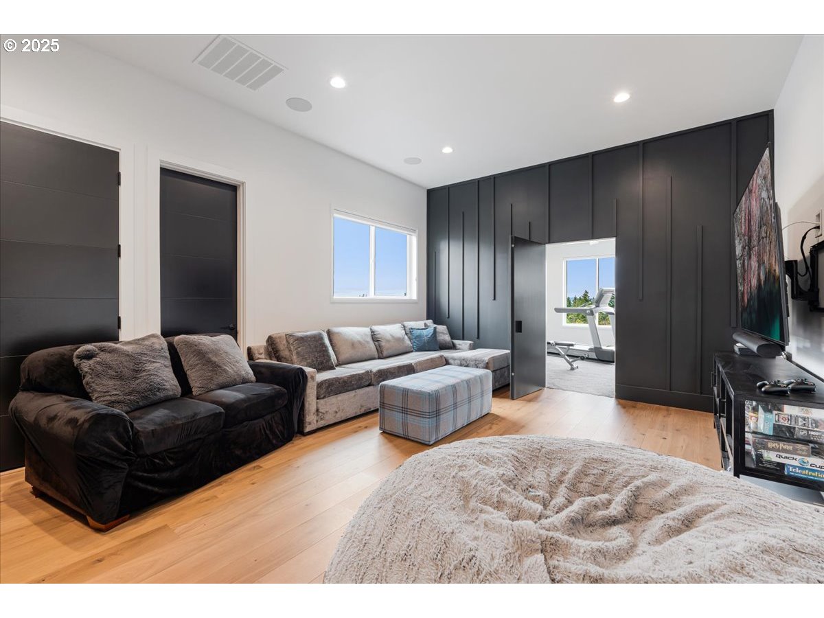 23067 Southwest Curry Ridge Drive Sherwood, OR 97140 - Photo 29 of 48 a living room with furniture and a flat screen tv