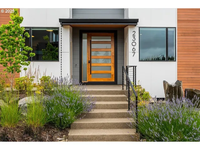 a front view of a house with a garden