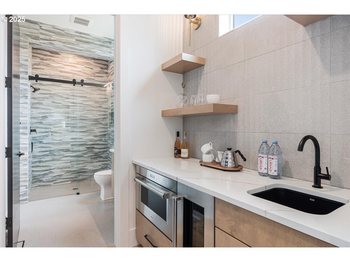 23067 Southwest Curry Ridge Drive Sherwood, OR 97140 - Photo 33 of 48 a kitchen with a sink and cabinets