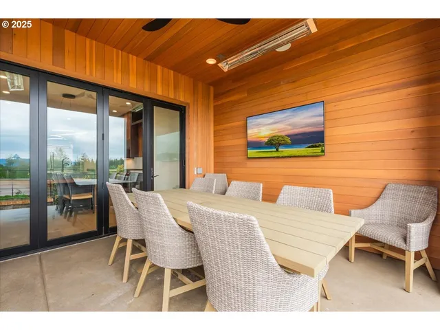 a view of a dining room with furniture and floor to ceiling window