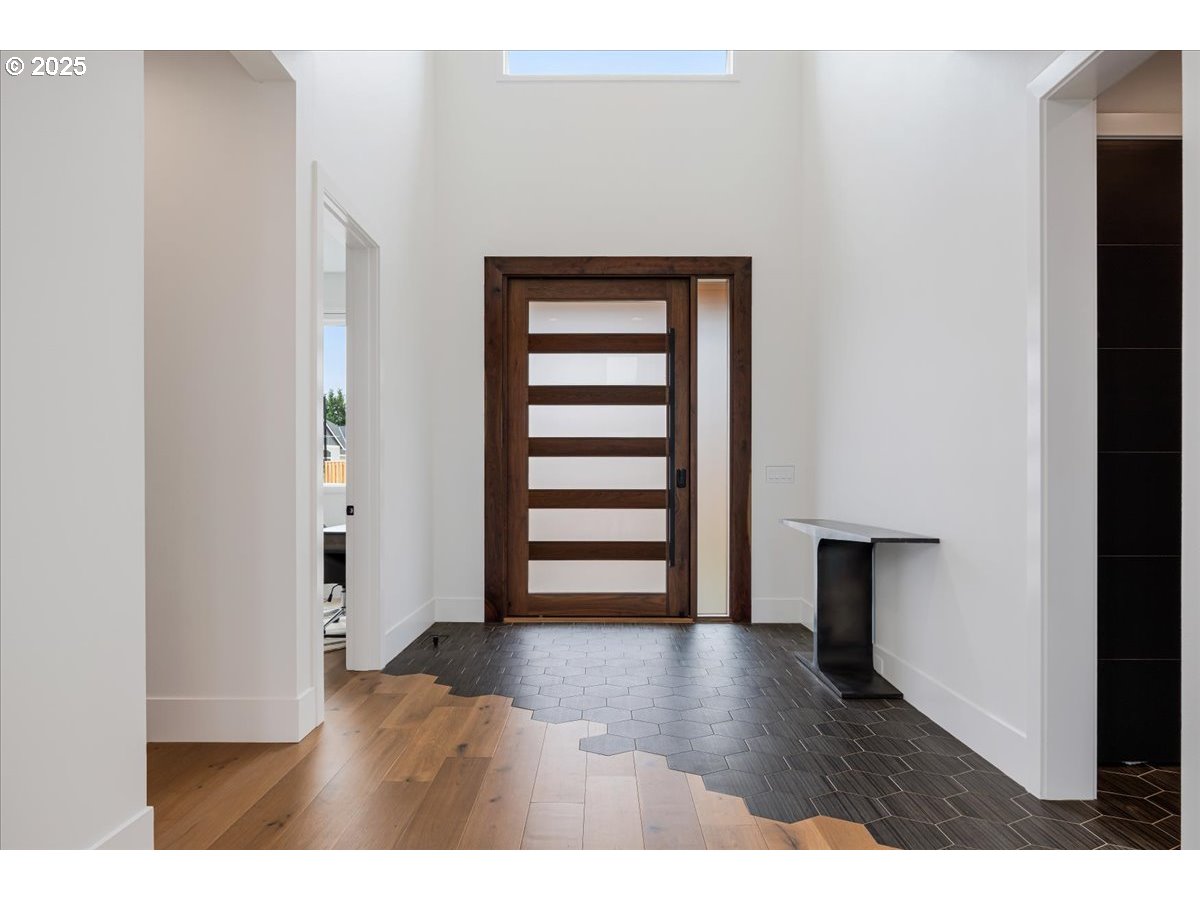 23067 Southwest Curry Ridge Drive Sherwood, OR 97140 - Photo 4 of 48 a view of empty room with wooden floor