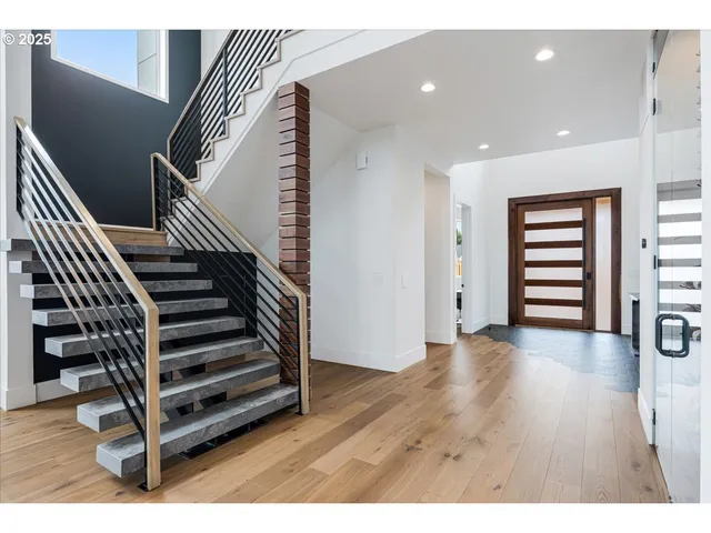 a view of an entryway with wooden floor