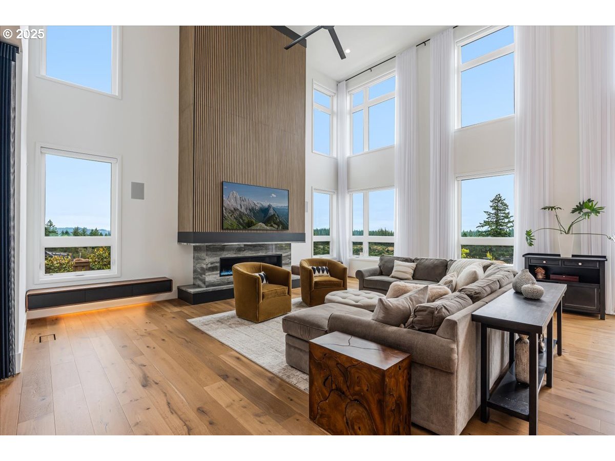 23067 Southwest Curry Ridge Drive Sherwood, OR 97140 - Photo 9 of 48 a living room with furniture and a flat screen tv