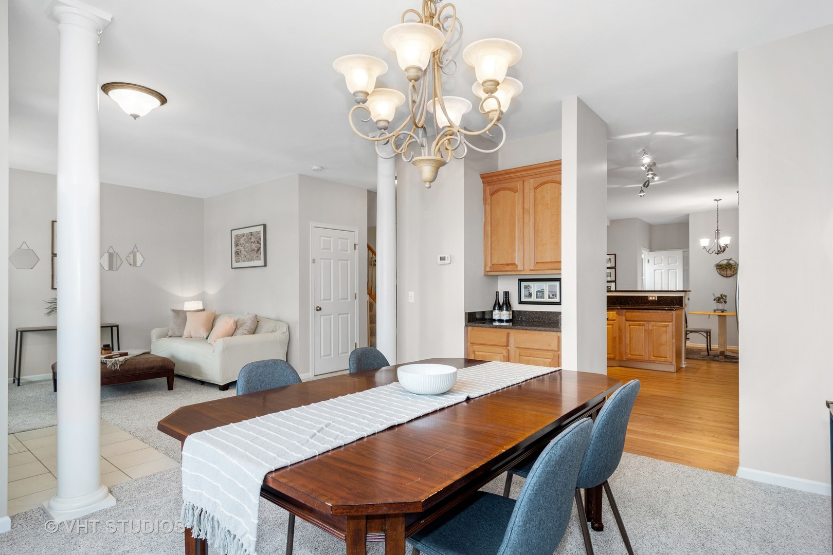 1931 Wagner Road Batavia, IL 60510 - Photo 10 of 27 a dining room with wooden floor a chandelier a wooden table and chairs