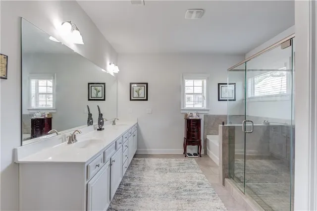 a spacious bathroom with a double vanity sink and a mirror