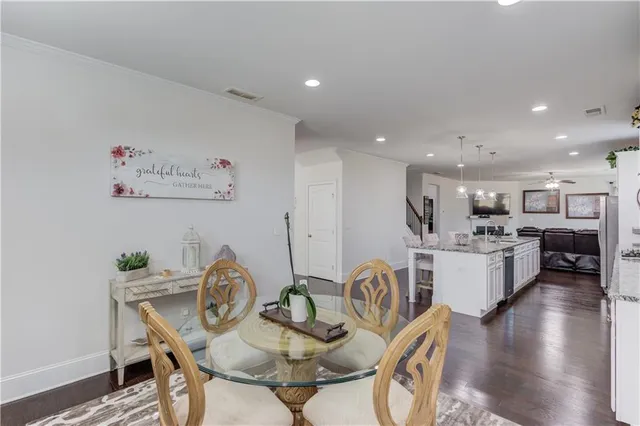 a view of a dining room with furniture and wooden floor