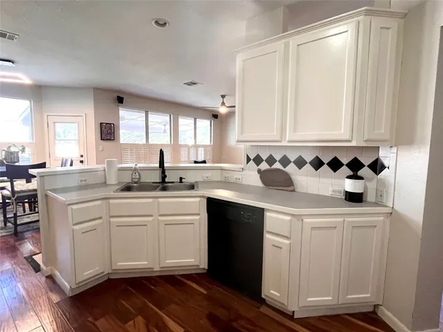 a kitchen with a sink cabinets and window