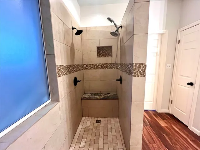 a bathroom with a shower and a shower