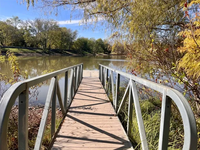 a view of balcony with wooden floor and fence