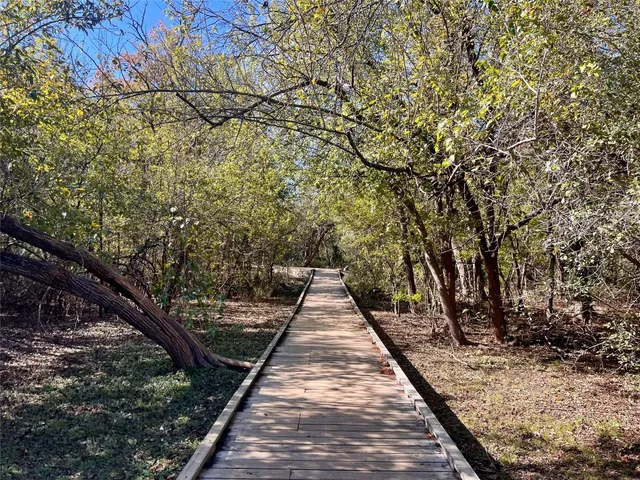 a view of flowing water with large tree