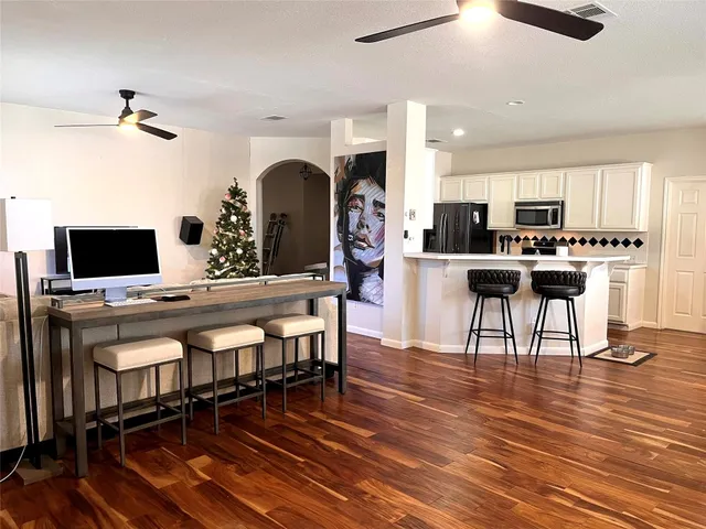 a view of a dining room with furniture and wooden floor