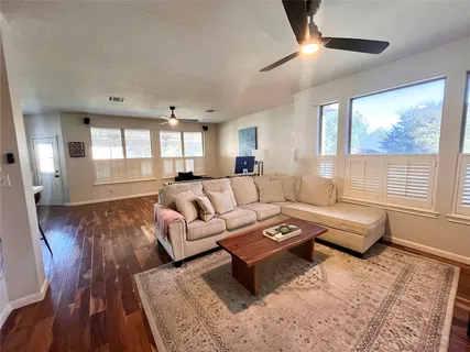 a living room with furniture and a large window