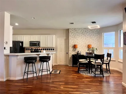 a view of a dining room with furniture and wooden floor