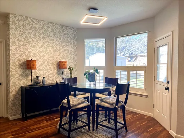 a dining room with furniture and window