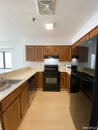 a kitchen with stainless steel appliances and view kitchen sink