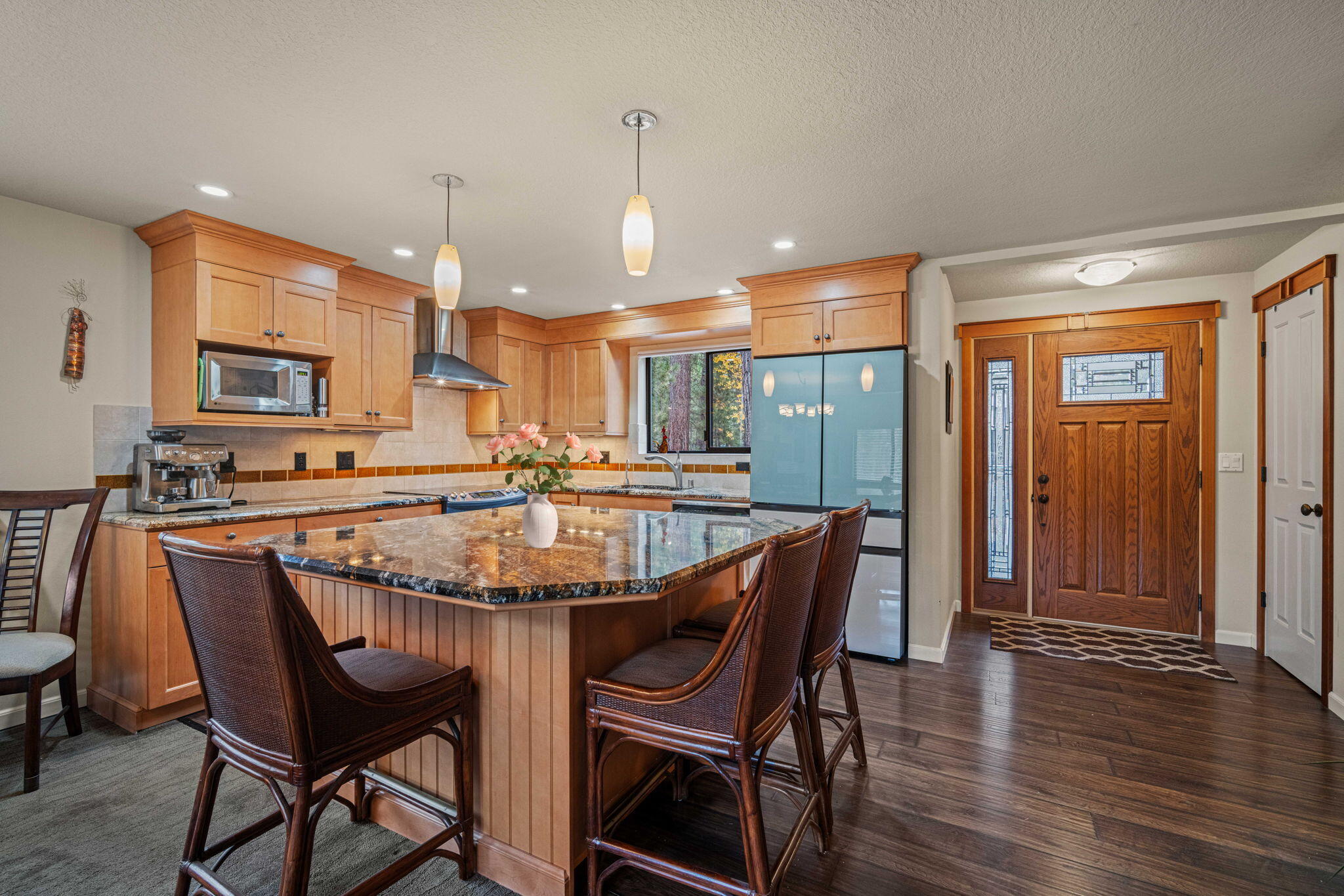 56019 Snow Goose Road Bend, OR 97707 - Photo 16 of 32 a dining table with chairs and kitchen view