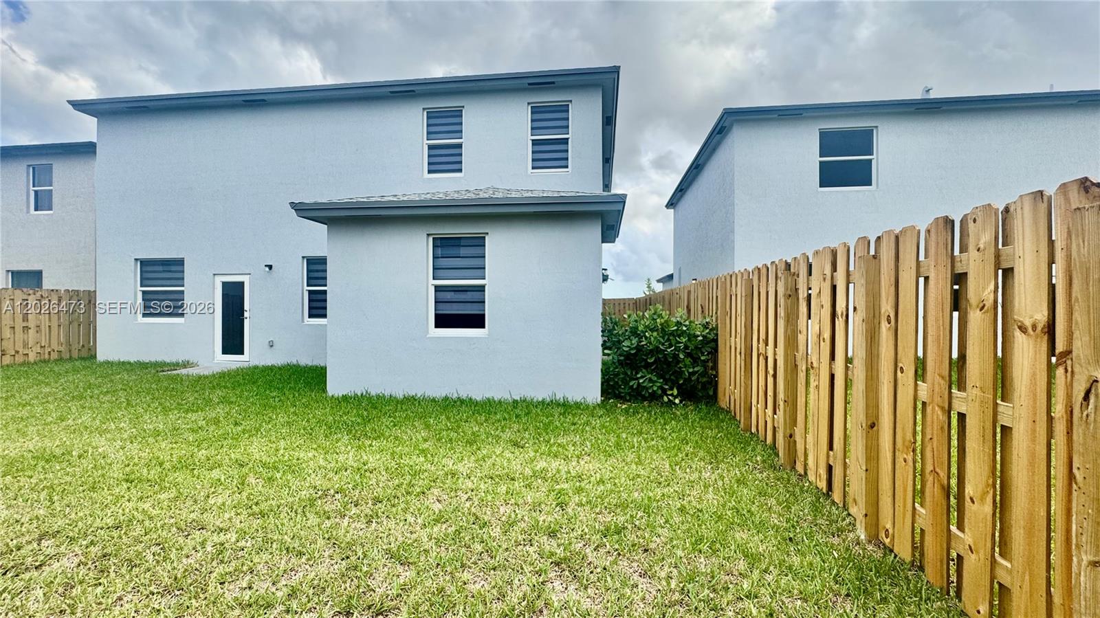 19479 Southwest 340th Street, Unit 1 Homestead, FL 33034 - Photo 48 of 58 a front view of a house with a yard