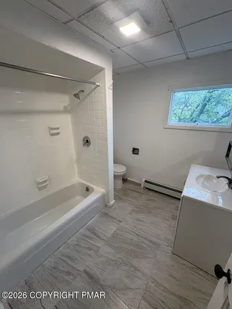 a bathroom with a bathtub and a shower