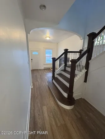 a view of entryway with wooden floor