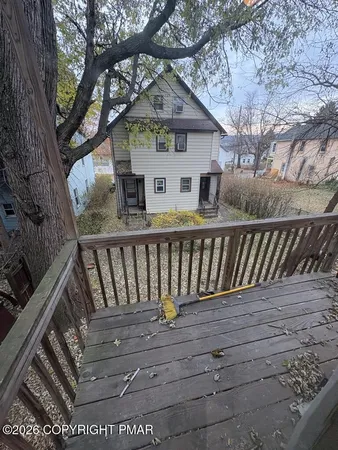 a view of a wooden deck and a yard