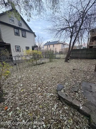 a view of a yard with large trees
