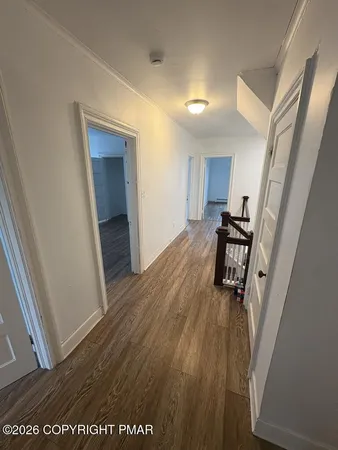 a view of a hallway and wooden floor
