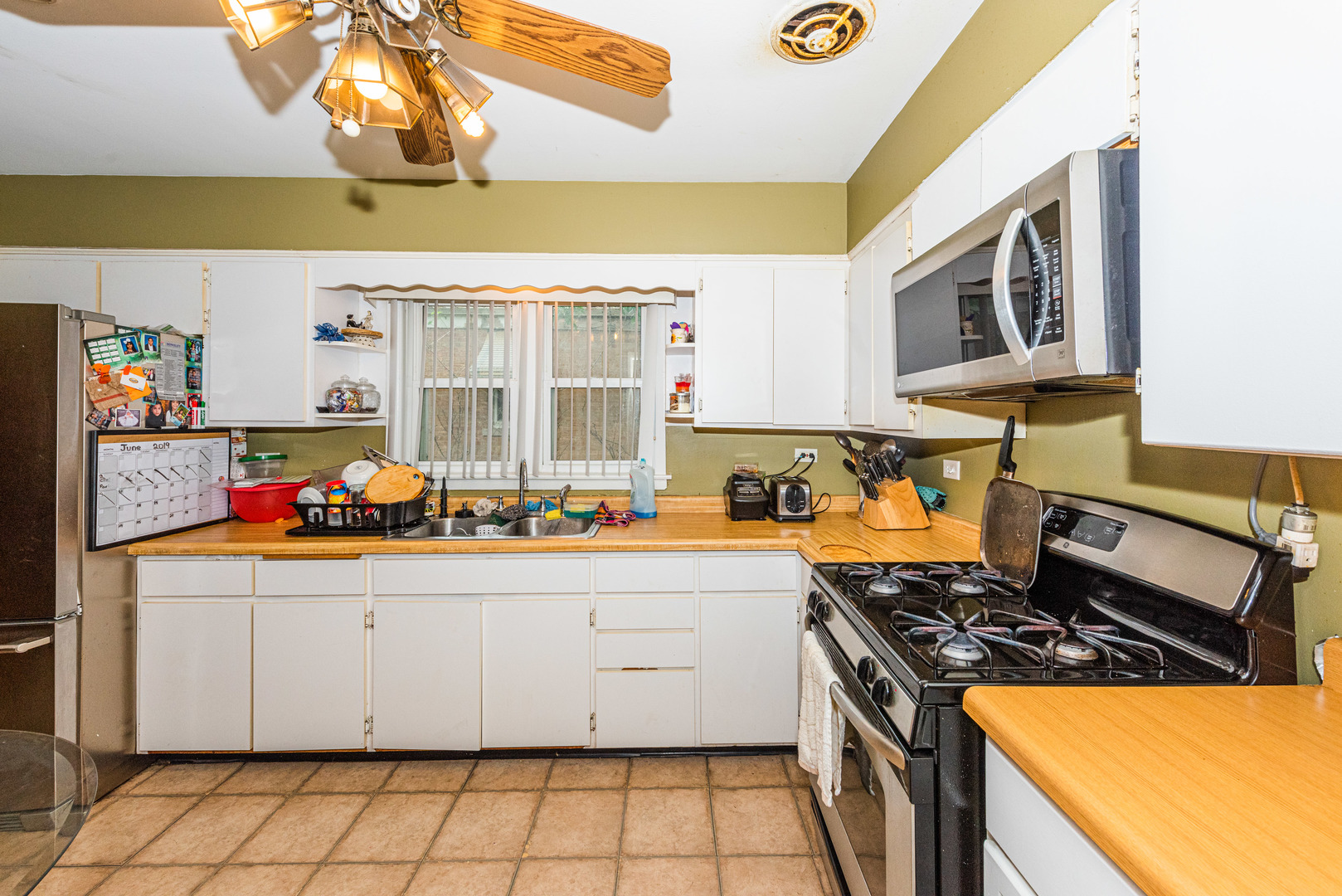 4645 Butterfield Road Hillside, IL 60162 - Photo 14 of 32 a kitchen with stainless steel appliances granite countertop a stove a sink and a refrigerator