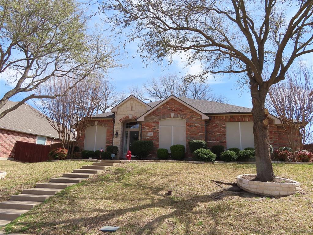 1448 Brittany Way Rockwall, TX 75087 - Photo 1 of 1 a front view of a house with a yard and garage