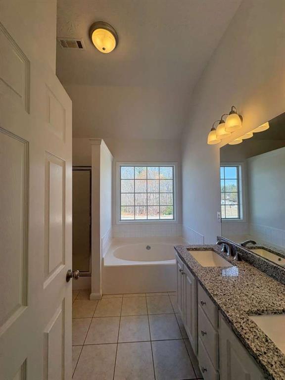 500 Shiver Boulevard Covington, GA 30016 - Photo 13 of 25 a bathroom with a granite countertop sink a mirror and a bathtub