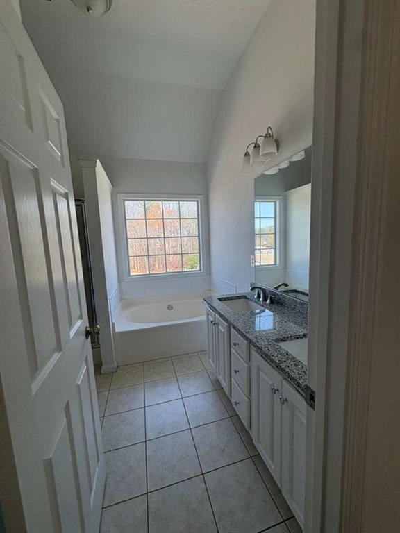 500 Shiver Boulevard Covington, GA 30016 - Photo 15 of 25 a bathroom with a granite countertop sink a toilet a mirror and vanity