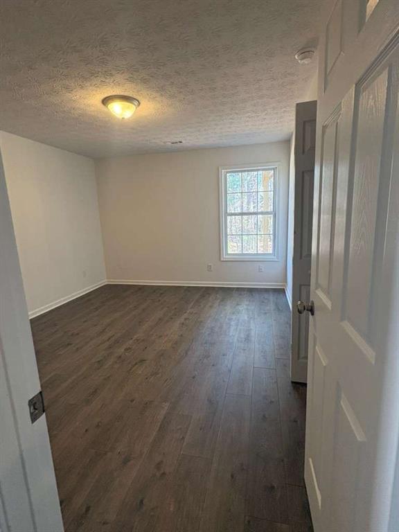 500 Shiver Boulevard Covington, GA 30016 - Photo 17 of 25 an empty room with wooden floor and windows