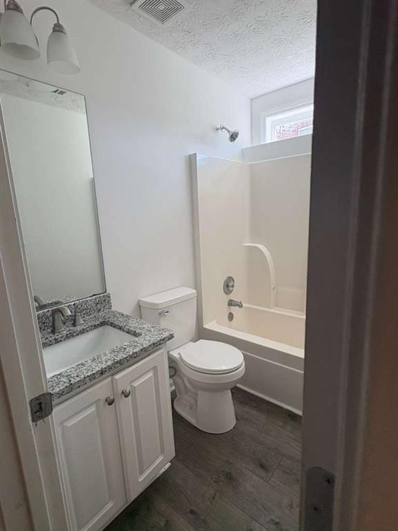 500 Shiver Boulevard Covington, GA 30016 - Photo 18 of 25 a bathroom with a granite countertop toilet a sink and a bathtub