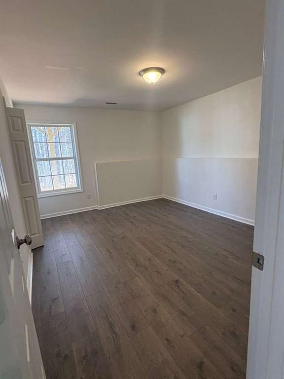 500 Shiver Boulevard Covington, GA 30016 - Photo 21 of 25 an empty room with wooden floor and windows