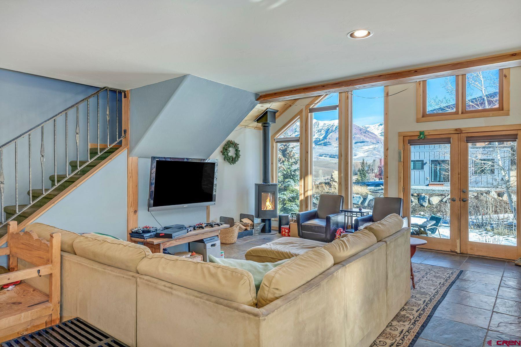 67 Paradise Road Crested Butte, CO 81225 - Photo 2 of 26 a living room with furniture and large flat screen tv