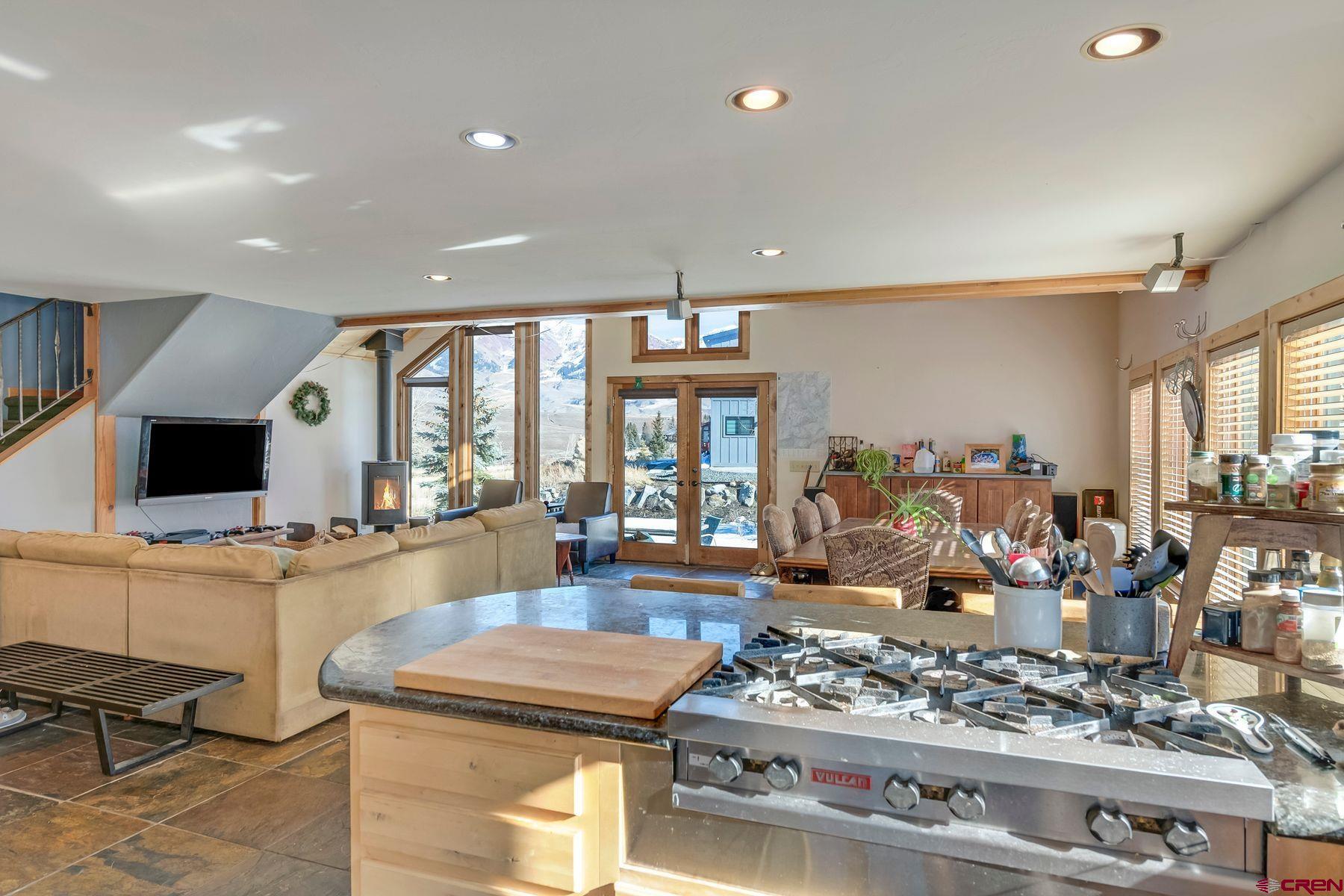 67 Paradise Road Crested Butte, CO 81225 - Photo 6 of 26 a kitchen with stainless steel appliances kitchen island granite countertop a stove and white cabinets