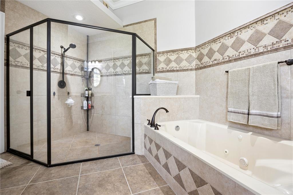 11325 Preston Cove Road Clermont, FL 34711 - Photo 24 of 58 a bathroom with a bathtub and a shower