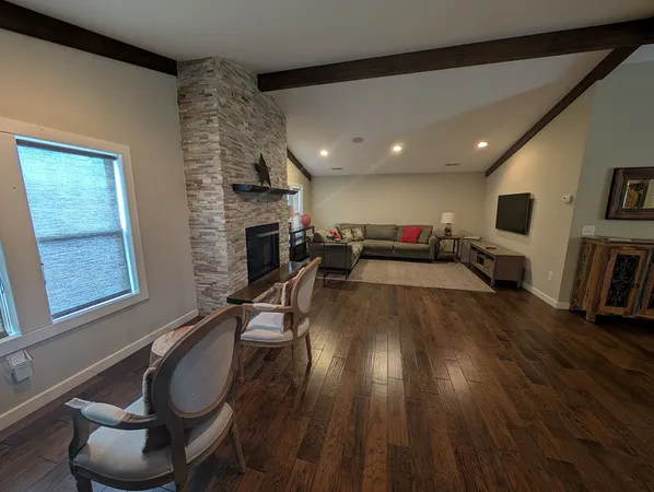 a living room with furniture and a fireplace