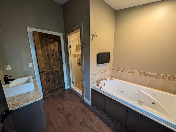 a bathroom with a tub and a sink