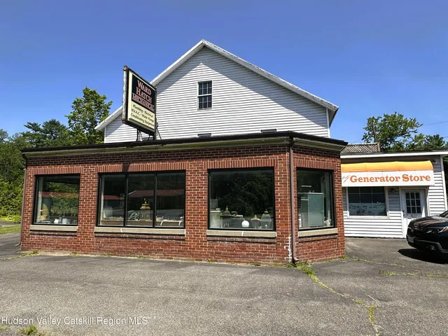 a view of a house with a outdoor space and parking