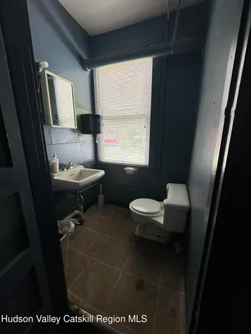 a bathroom with a toilet sink and window