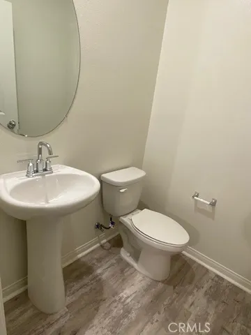 a white toilet sitting next to a bathroom sink