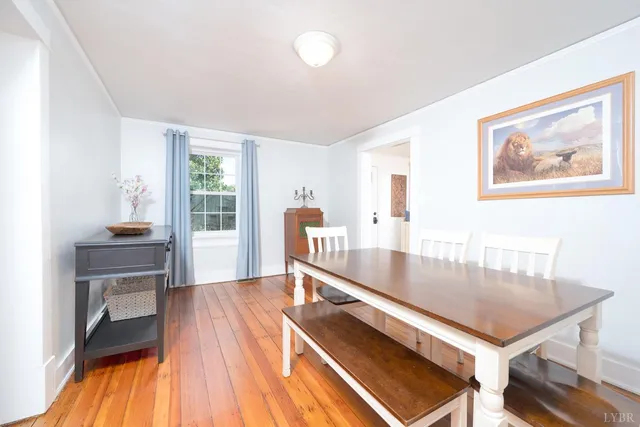 a kitchen with stainless steel appliances white cabinets and wooden floor