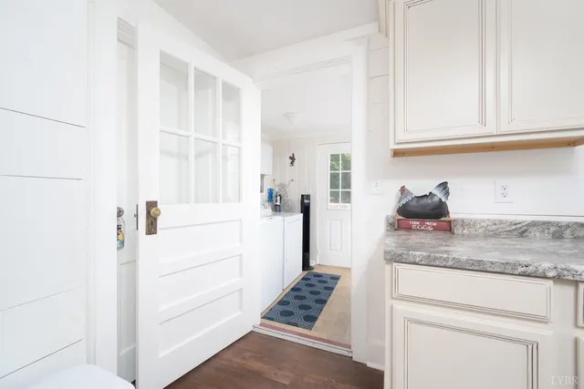 a bedroom with a large bed and a flat tv screen on dresser